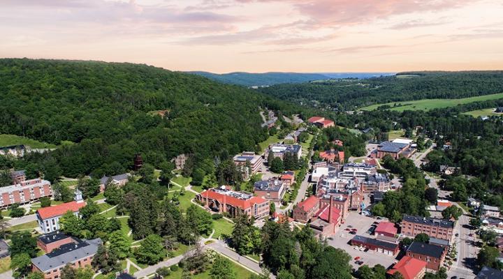 aerial drone view of campus with lush pink sky at sunset